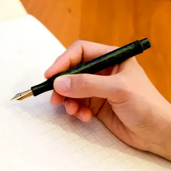 eboya kyouka small fountain pen held in hand ready to write