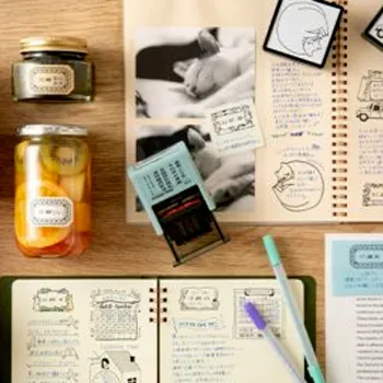 examples of midori travel-themed stamp impressions on a notebook