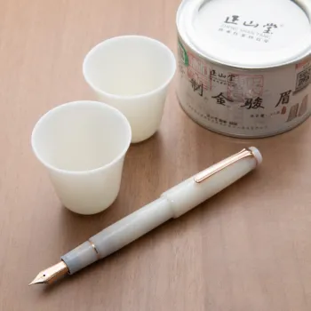 nagasawa blanc de chine fountain pen with porcelain white body with two white porcelain vessels