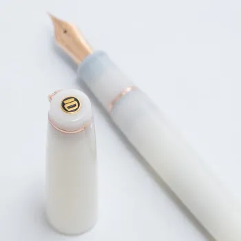 circular emblem on the top of the cap, inspired by the seal used in Kobe INK Monogatari bottles