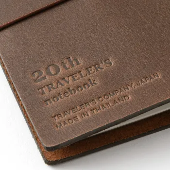 Close-up of the 20th Anniversary embossing on the TRAVELER’S notebook Card Size Brown leather cover